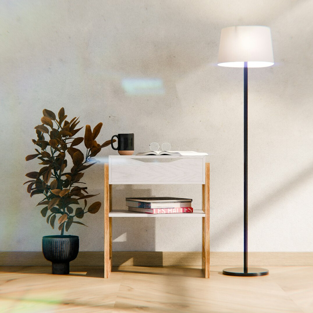 Warm reading lamp beside an open book on a side table