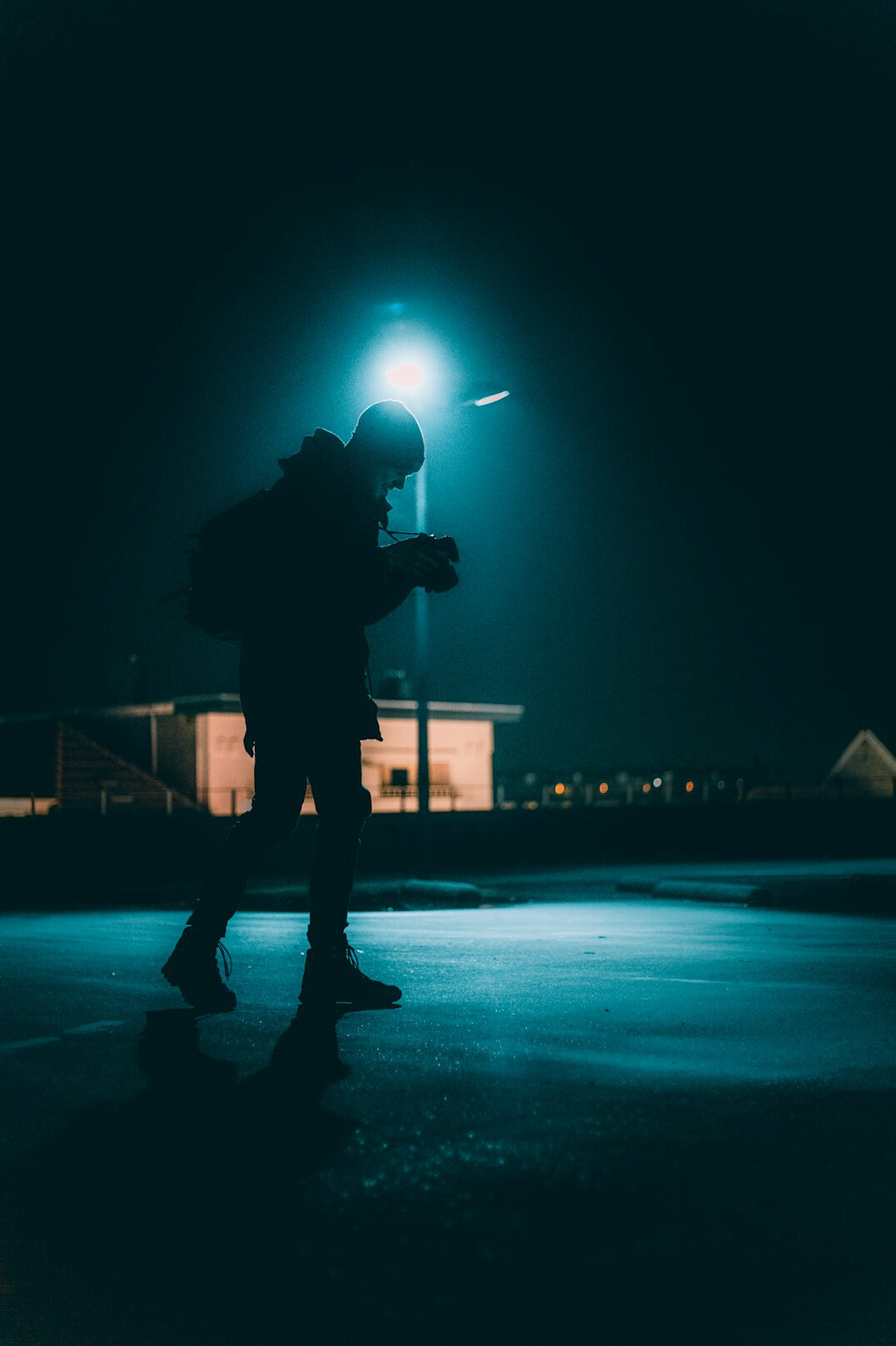Anonymous silhouette of a man under a streetlight at night