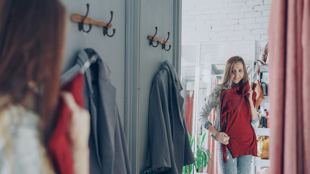 woman trying on clothes in fitting room