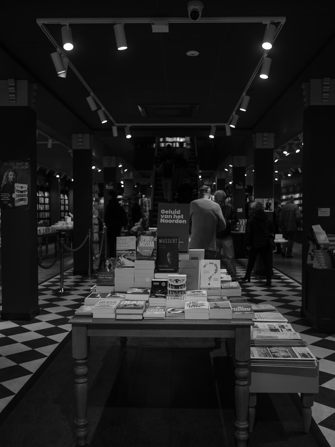 Stack of hardcover books on a wooden table