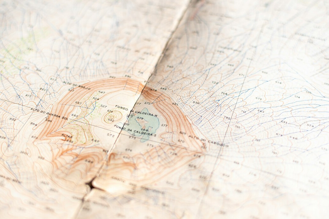 Old paper map with a magnifying glass